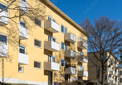 Ett äldre gult bostadshus i Hammarbyhöjden photo