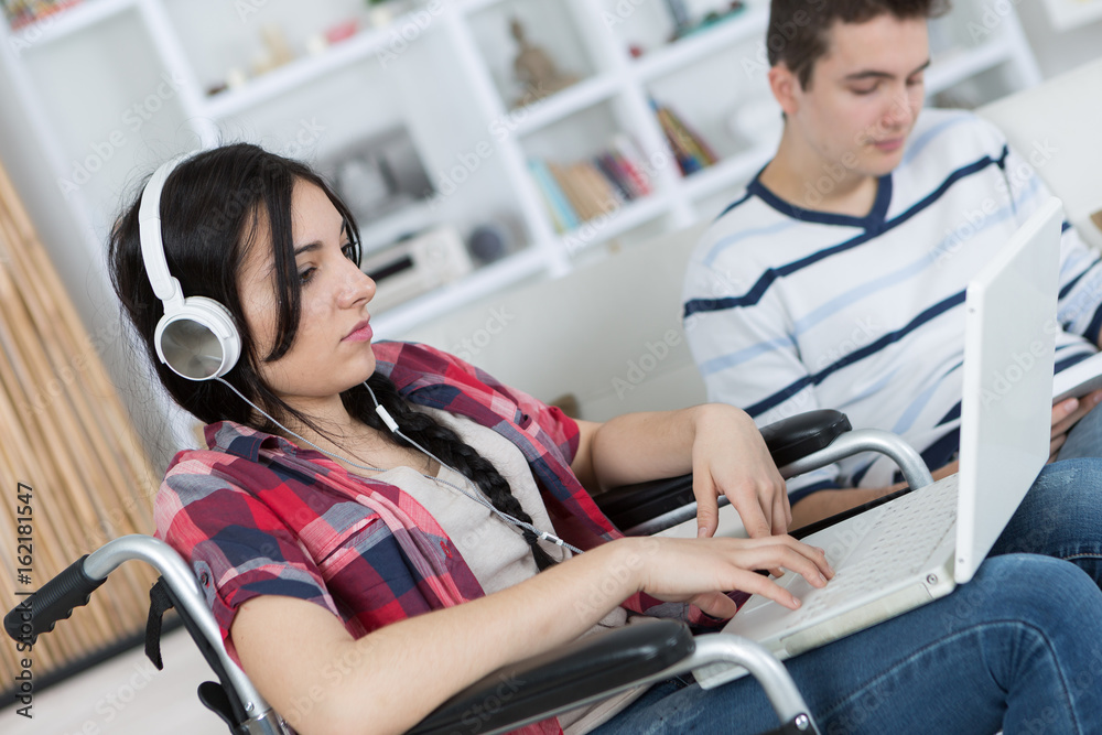 Adolescent in wheelchair using computer Adolescent in wheelchair using computer