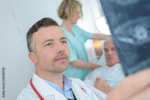 male doctor reviewing patients x ray at hospital