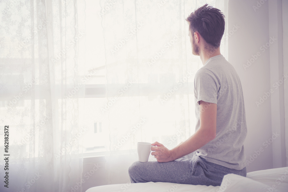 Portrait of bedroom concept: Man holding a cup of coffee with on bedroom. Portrait of bedroom concept: Man holding a cup of coffee with on bedroom.