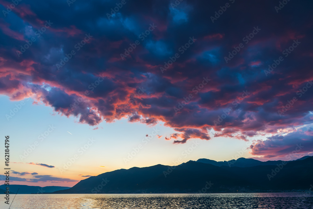 Sunset in the sky of Montenegro over the high mountains.