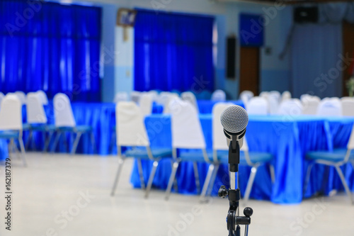 Wallpaper Mural microphone wireless on a stand in  meeting room seminar empty conference background: Select focus with shallow depth of field. Torontodigital.ca