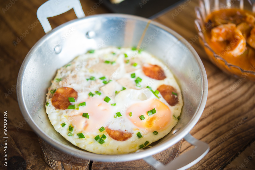 Panned egg top with sausage, traditional asian style breakfast . Panned egg top with sausage, traditional asian style breakfast .