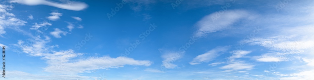 Panorama of blue sky background with white clouds on a sunny day - obrazy, fototapety, plakaty 