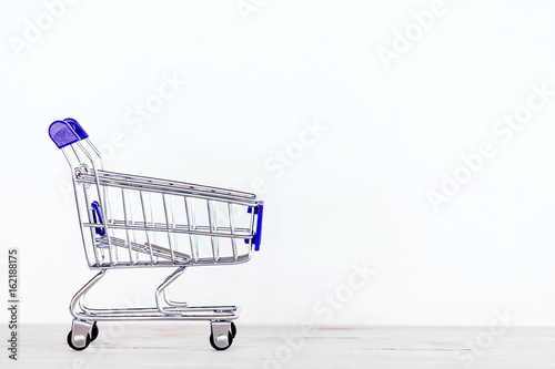 Shopping cart on the wooden © Art_Photo
