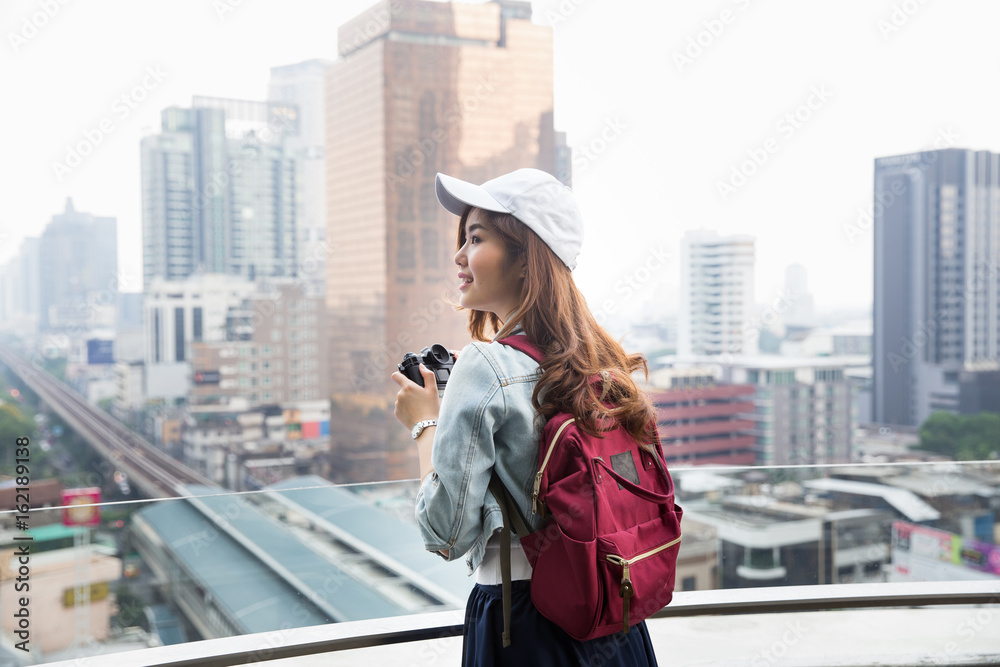 Young asian lady traveling in city center
