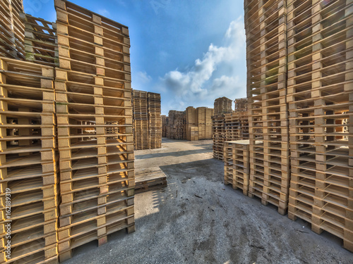 Business area with huge piles of euro cargo pallets
