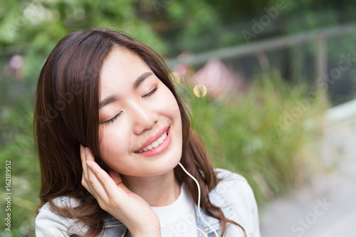Young asian lady listen to music