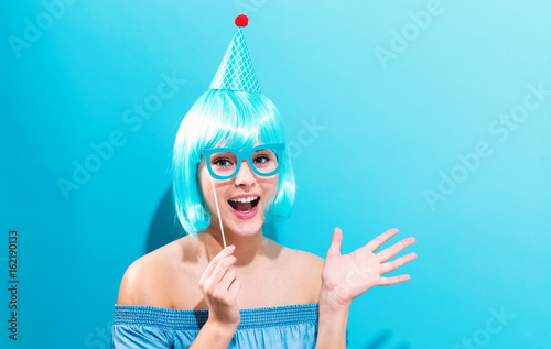 Party theme with a woman in a bright blue wig