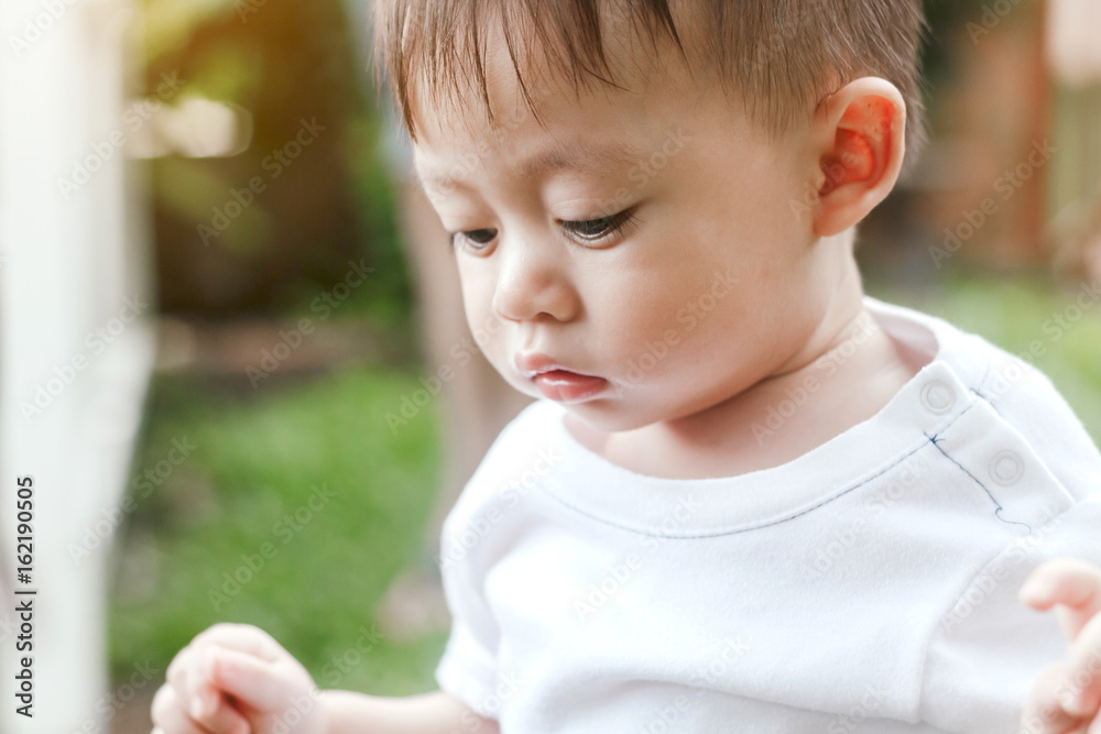 Asian baby boy look somewhere in the park Asian baby boy look somewhere in the park