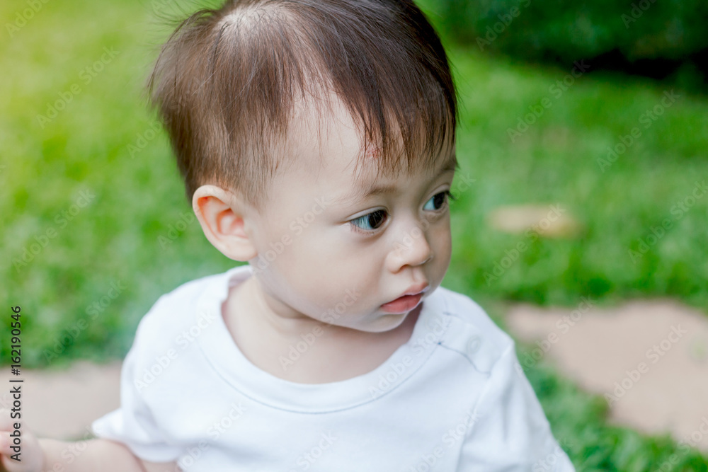 Asian baby boy look somewhere in the park Asian baby boy look somewhere in the park