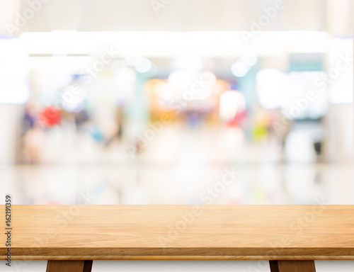 Empty wood board table at blur department store bokeh light background,Mock up for display or montage of product or design
