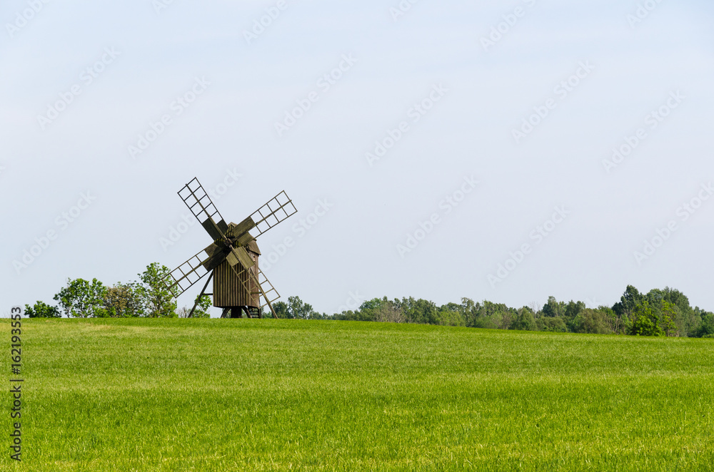 Fototapeta premium Old wooden windmill in a field