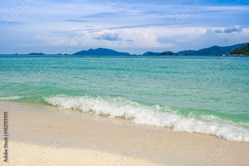 Sea view from tropical beach with sunny sky. Summer paradise beach of lipe island. Tropical shore. Tropical sea in lipe thailand.turquoise Ocean beach relax, outdoor travel. © kenchiro168