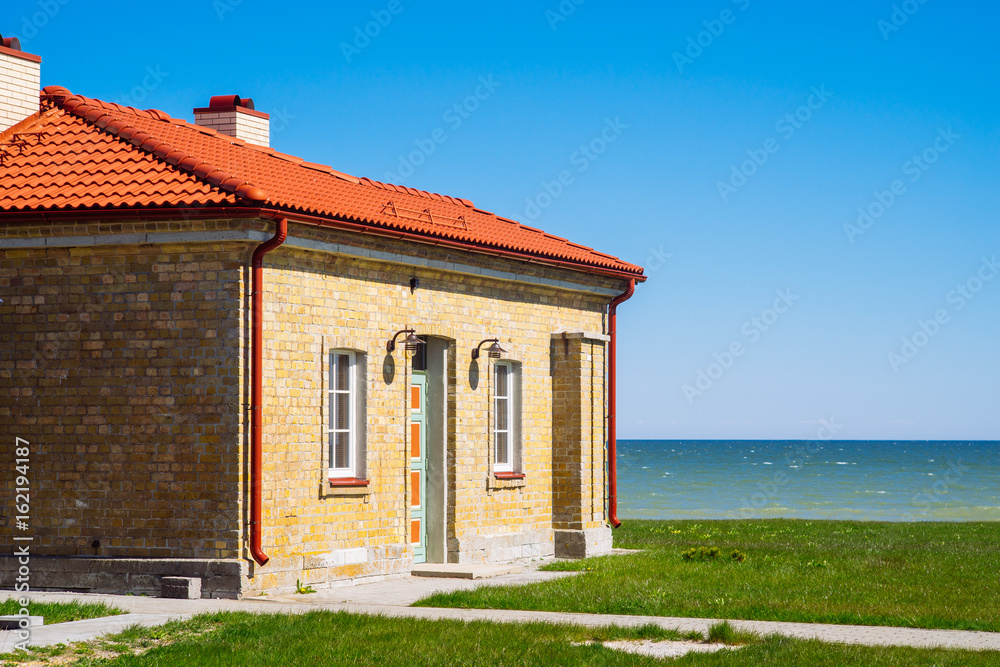 Brick house by the sea on sunny day Brick house by the sea on sunny day