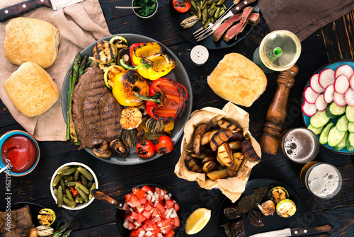 Meat and vegetables grill with wine and beer