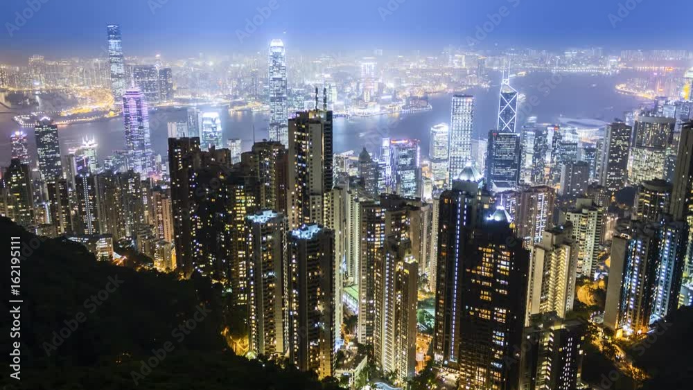 Time lapse Hong Kong skyline from famous The Peak view point at night. Wow-Effect: Clouds rushing through skyscrapers. Time lapse Hong Kong skyline from famous The Peak view point at night. Wow-Effect: Clouds rushing through skyscrapers.