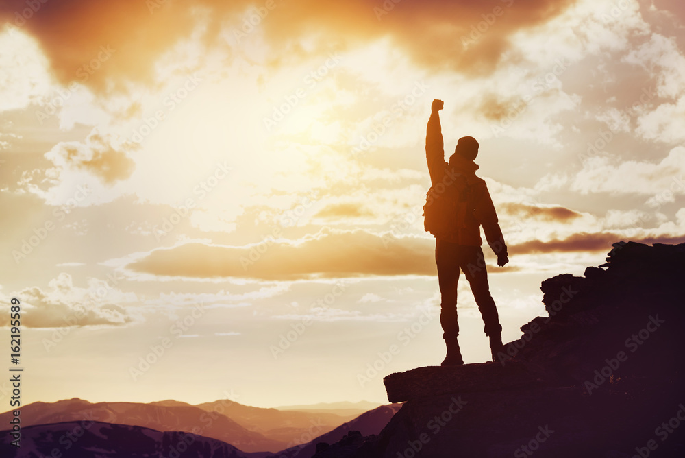 Fototapeta premium Man winner mountain top silhouette
