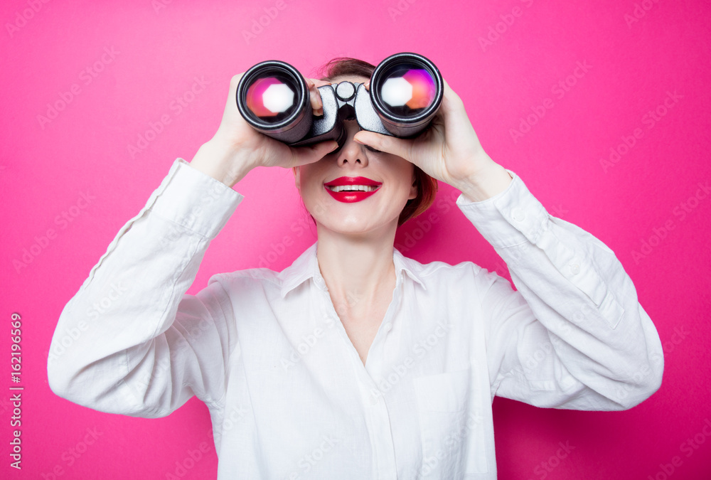 Beautiful red-haired businesswoman with binoculars Beautiful red-haired businesswoman with binoculars