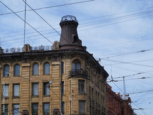 Tradition yellow facade with tower of house in old city of Saint-Petersburg, Russia 