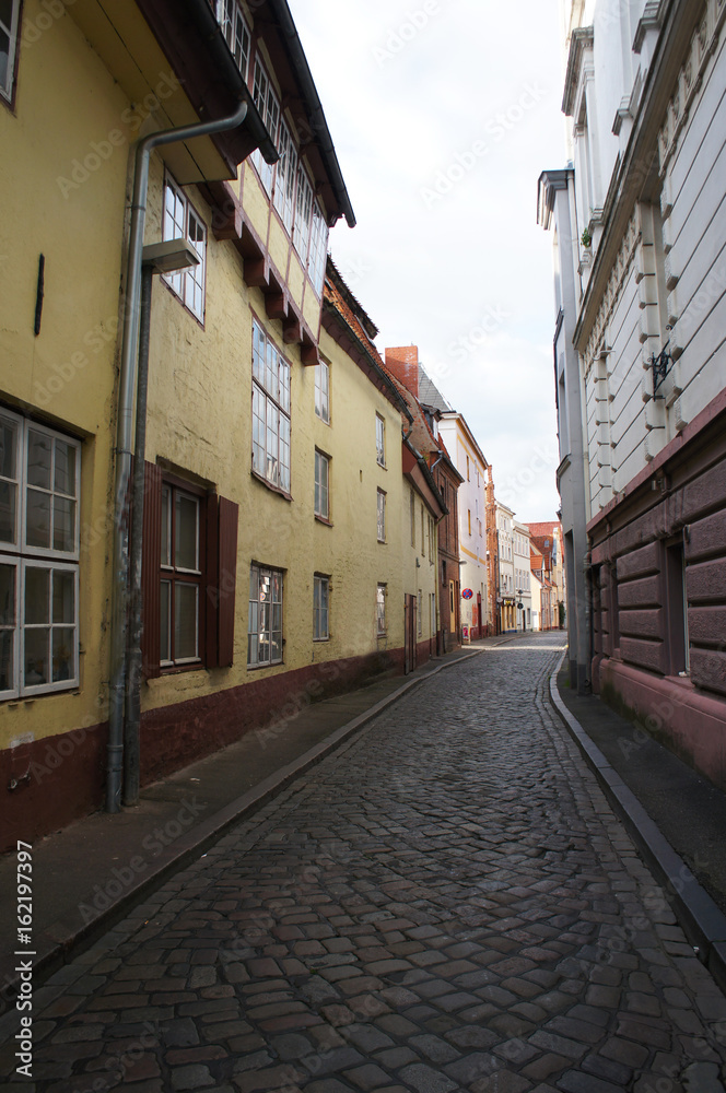 Narrow street in old city in Lubeck, Germany