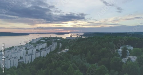 Evening aerial view of apartment houses by the lake in Lahti, Finland, sideways movement