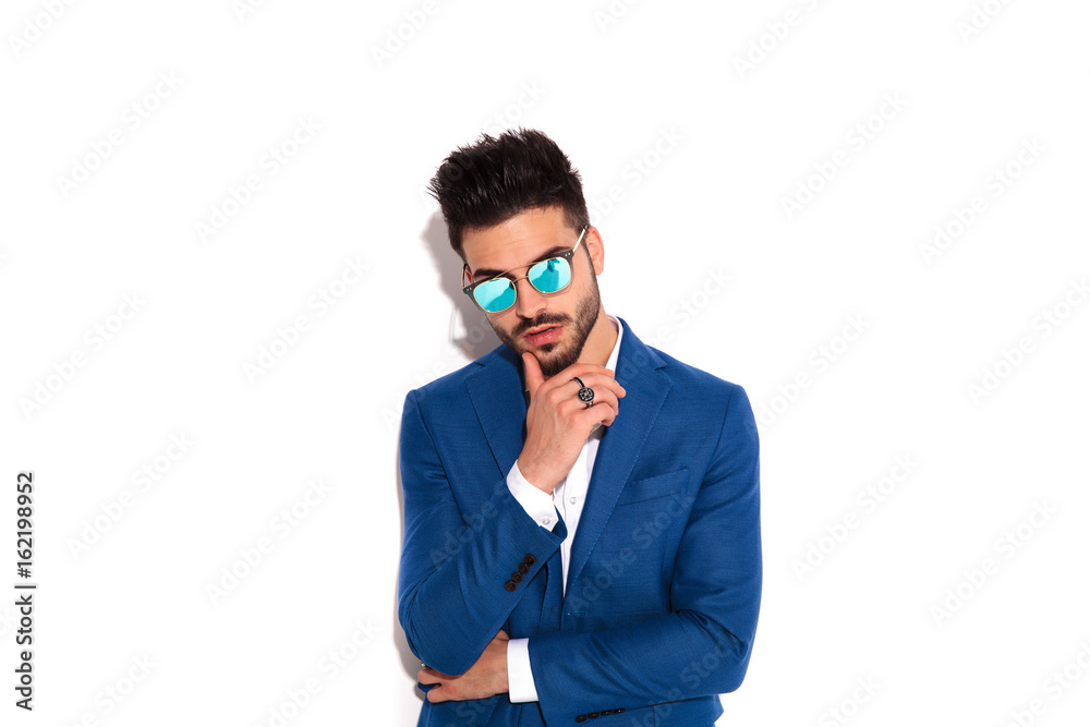 fashion elegant man holding his chin on finger and thinks fashion elegant man holding his chin on finger and thinks