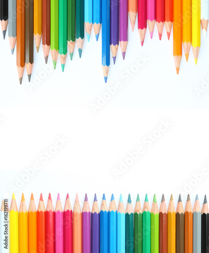 colored pencils row with wave on white background.