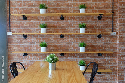 Planted on a wooden rack, brick background