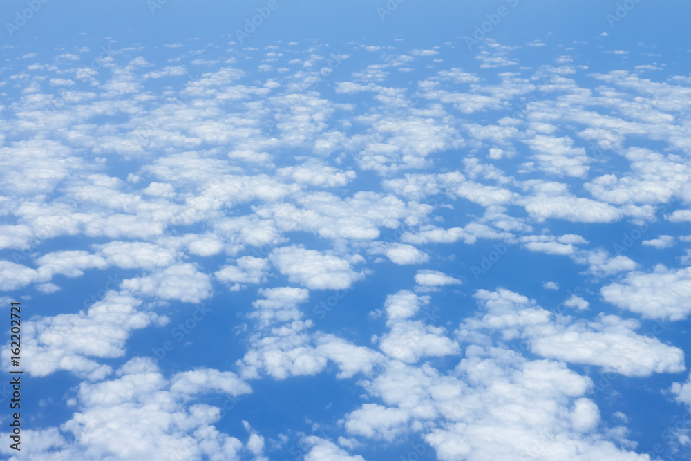 cloud scape on blue sky background from airplane window