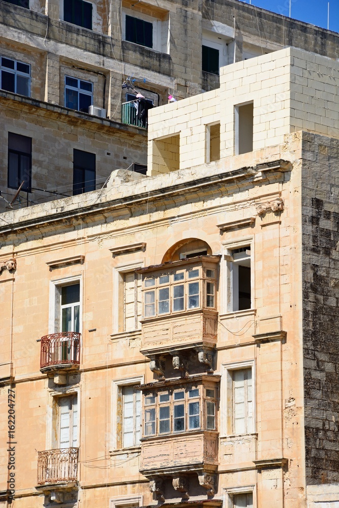 Traditional buildings with balconies in the city centre, Valletta, Malta.