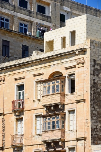 Traditional buildings with balconies in the city centre, Valletta, Malta.