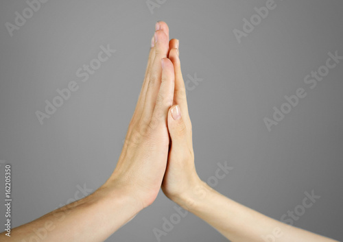 Women's men's palm touches palm. High five. Isolated