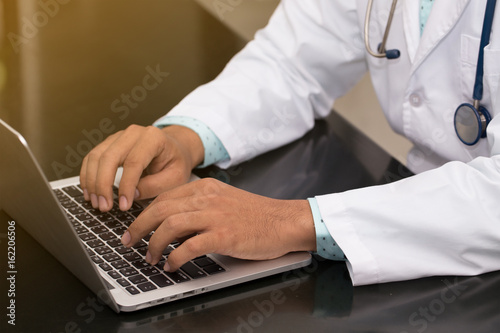doctor typing notebook in hospital