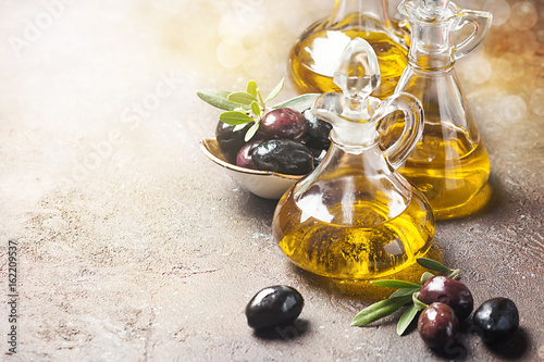 Olive oil and olive branch photo