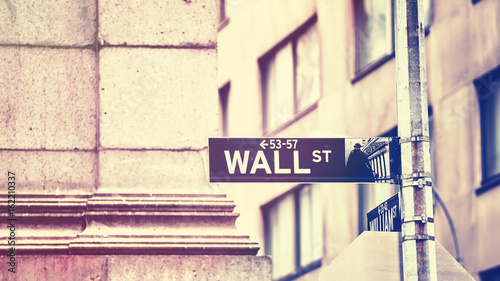 Wall Street sign, shallow depth of field, color toning applied, New York City, USA.