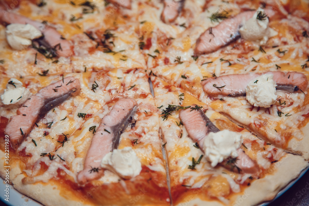 Traditional Italian pizza with salmon and mozzarella cheese.