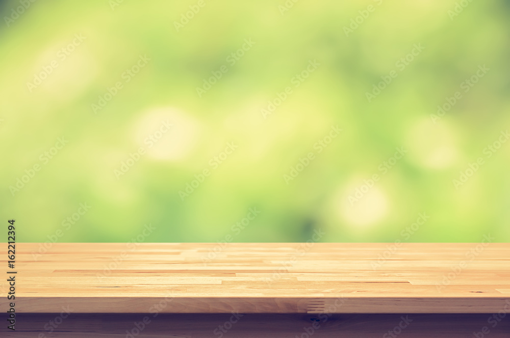 Wood table top on green bokeh abstract background, vintage tone Wood table top on green bokeh abstract background, vintage tone