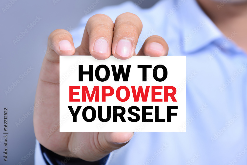 HOW TO EMPOWER YOURSELF message on the card shown by a man HOW TO EMPOWER YOURSELF message on the card shown by a man