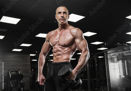 Brutal bodybuilder athletic man with six pack  perfect abs  shoulders  biceps  triceps and chest    Brutal bodybuilder athletic man with six pack  perfect abs  shoulders  biceps  triceps and chest