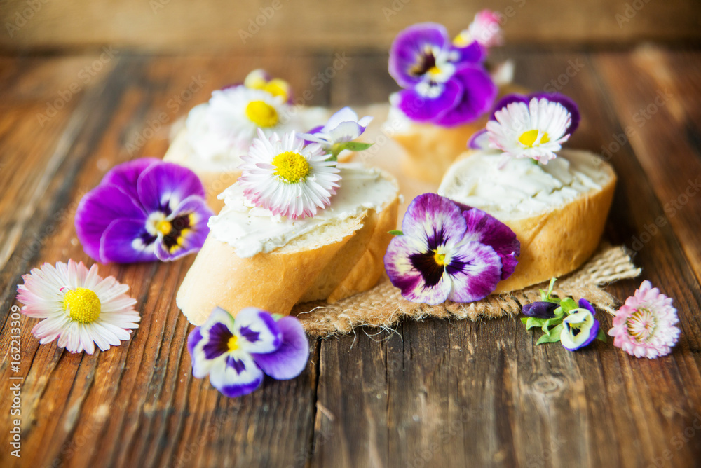 Sandwich with herb and edible flowers butter on marble cutting board. Healthy food. Sandwich with herb and edible flowers butter on marble cutting board. Healthy food.