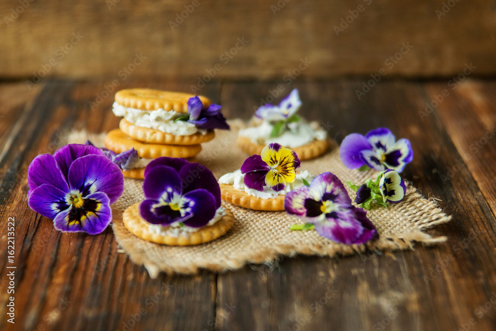 Sandwich with herb and edible flowers butter on wooden background, healthy food. Sandwich with herb and edible flowers butter on wooden background, healthy food.
