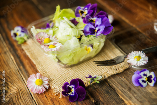 Spring salad with radishes  edible flower and sauce  selective focus