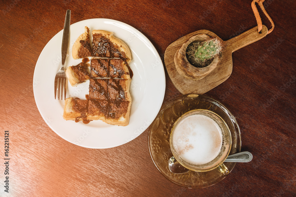 Hot coffee with bread on wooden table background. Hot coffee with bread on wooden table background.