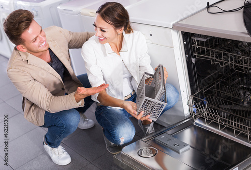 Photos Family selecting modern dishwasher