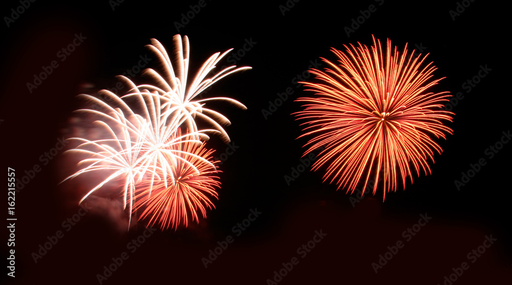 Abstract fireworks light up in the sky at night