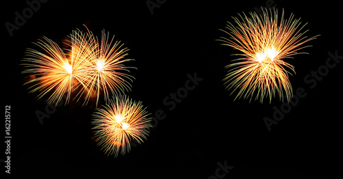 Abstract fireworks light up in the sky at night