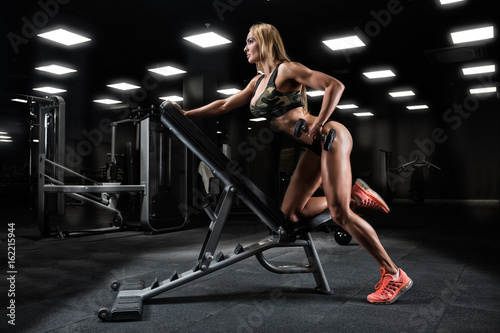 fitness girl exercising with barbell in gym