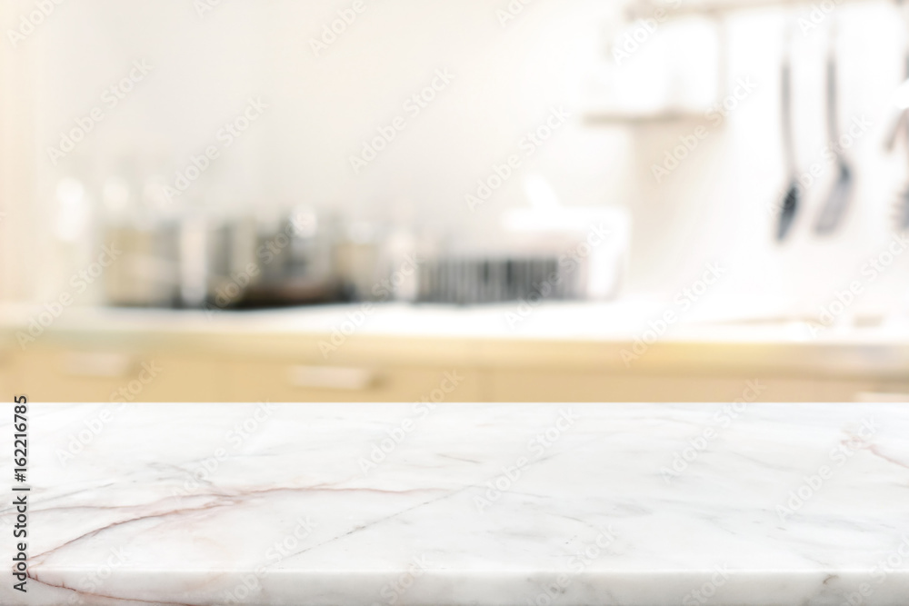 Marble stone table top (kitchen island) on blur kitchen interior background - obrazy, fototapety, plakaty 