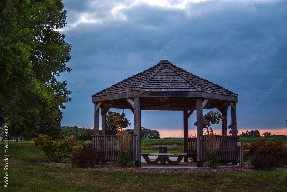 large rustic gazebo with a picnic table in the center large rustic gazebo with a picnic table in the center